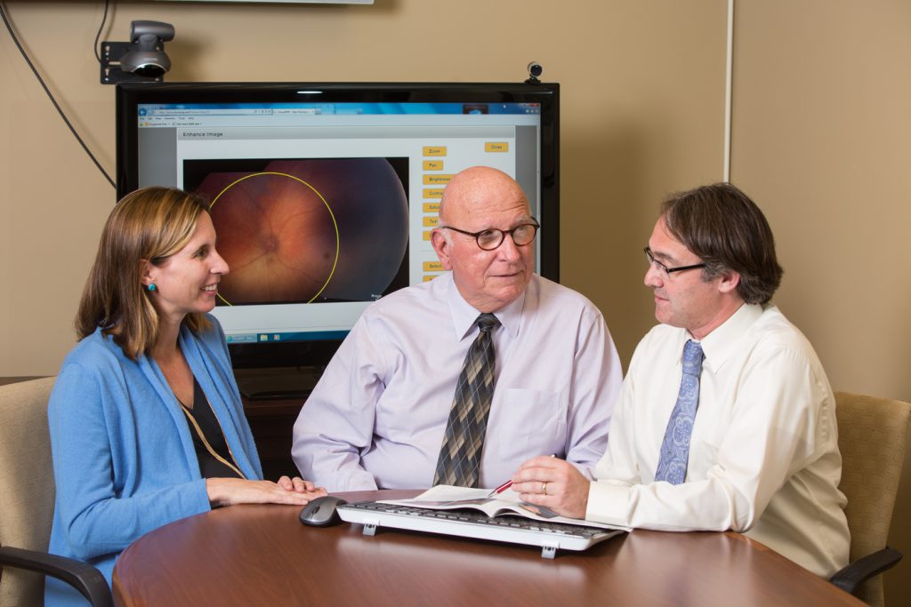 Michael Trese, M.D. (center) talks with Maria Woodward, M.D., (left), associate professor of ophthalmology and visual sciences, University Michigan, and Cagri Besirli, M.D., assistant professor, University of Michigan. (Photo courtesy of Michigan Medicine)